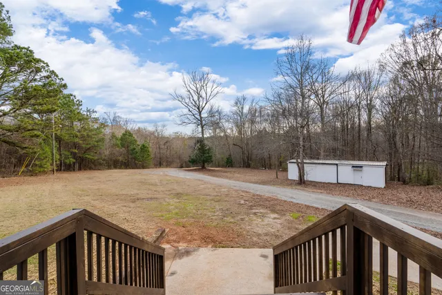 a view of a livingroom with wooden floor and stairs
