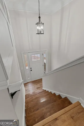 wooden floor fireplace and windows in an empty room