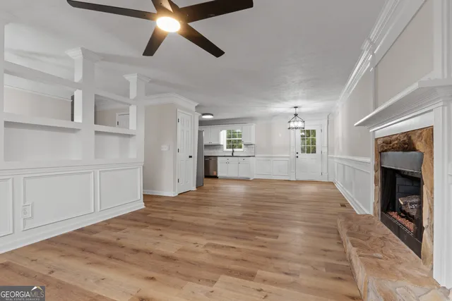 a kitchen with stainless steel appliances granite countertop a stove top oven a sink and cabinets