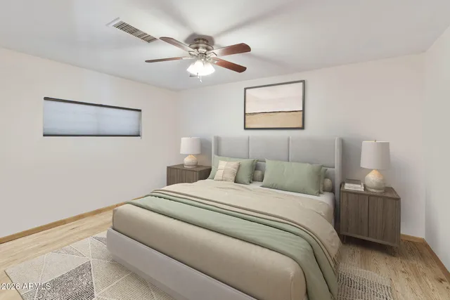 a bedroom with a bed and a painting on the wall