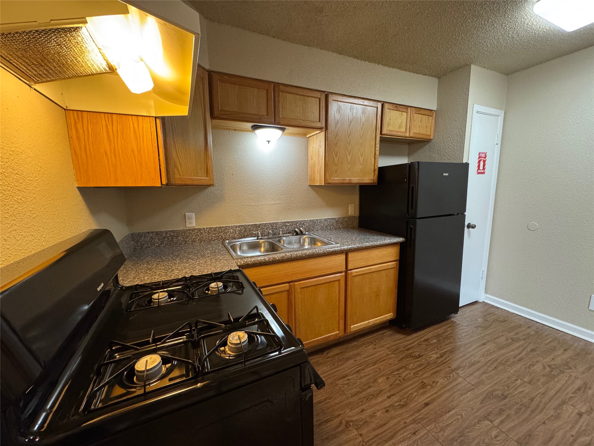 4904 West Wind Trail, Unit 102 Austin, TX 78745 - Photo 7 of 23 a stove top oven sitting inside of a kitchen