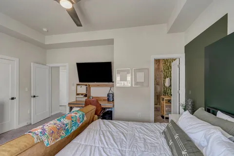 a bedroom with a bed and a flat screen tv