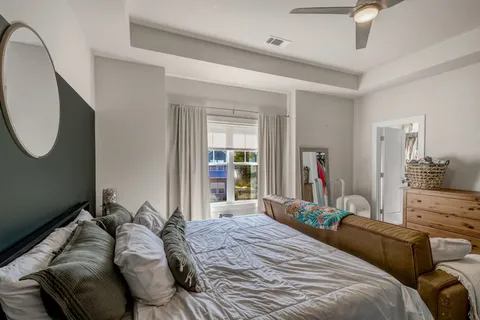 a bedroom with bed and a large mirror