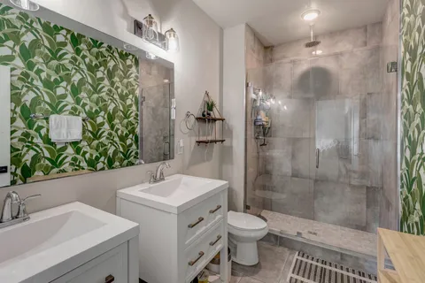 a bathroom with a sink toilet and shower