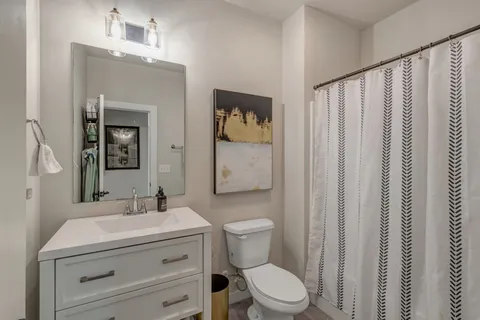 a bathroom with a toilet a sink and a mirror