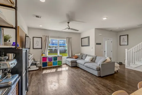 a living room with furniture and wooden floor