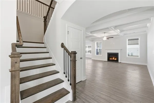 a view of a livingroom with wooden floor and fireplace