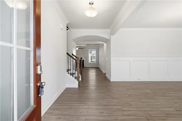 a view of a hallway view with wooden floor and staircase