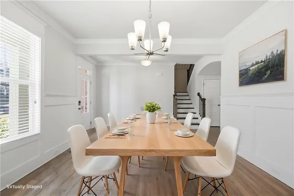 a view of a dining room with furniture wooden floor and chandelier