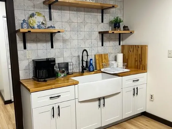 a kitchen with a sink cabinets and wooden floor