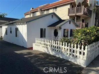 a front view of a house with a fence