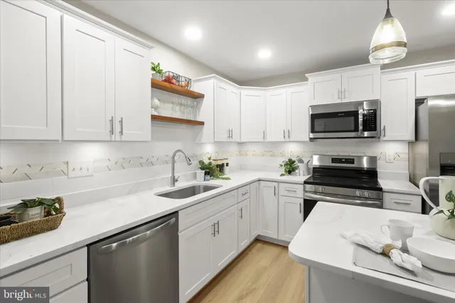 a kitchen with a sink a stove and microwave