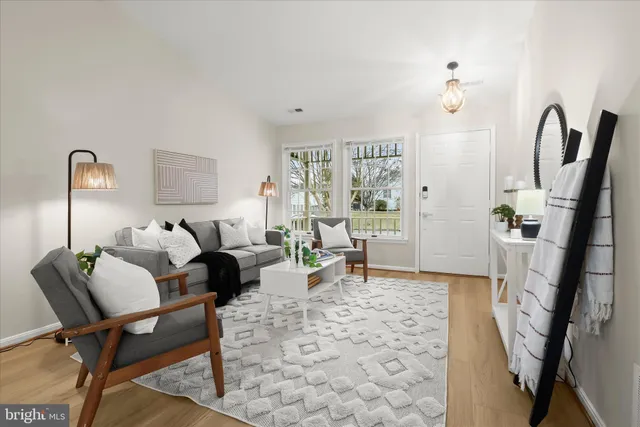 a living room with furniture rug and a lamp