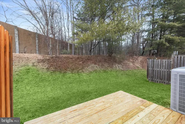 a view of a backyard with wooden fence