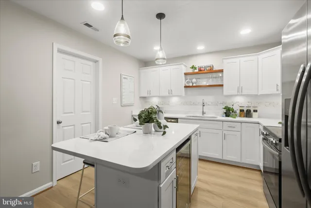 a kitchen with kitchen island a sink counter and chairs