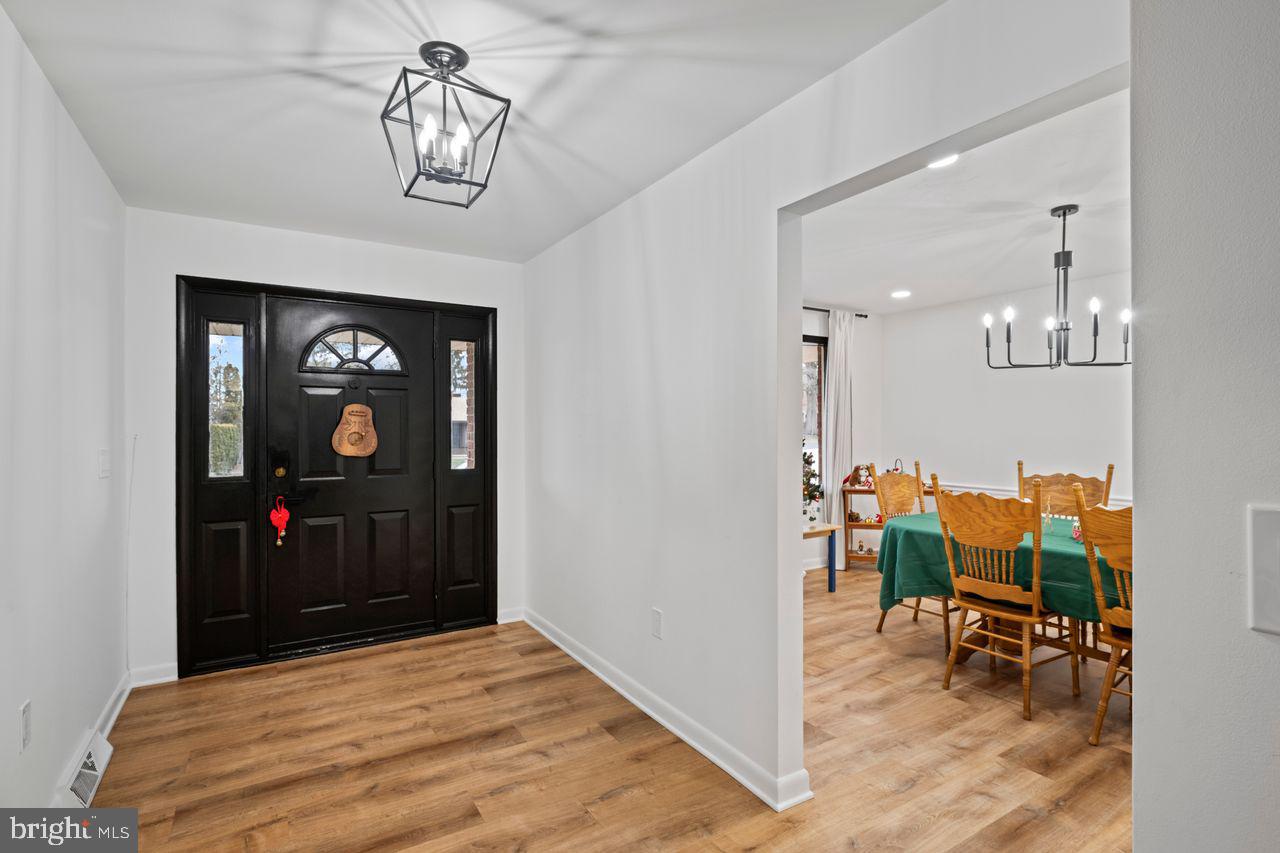 1958 High Street York, PA 17408 - Photo 4 of 38 a view of a hallway with wooden floor and a chandelier