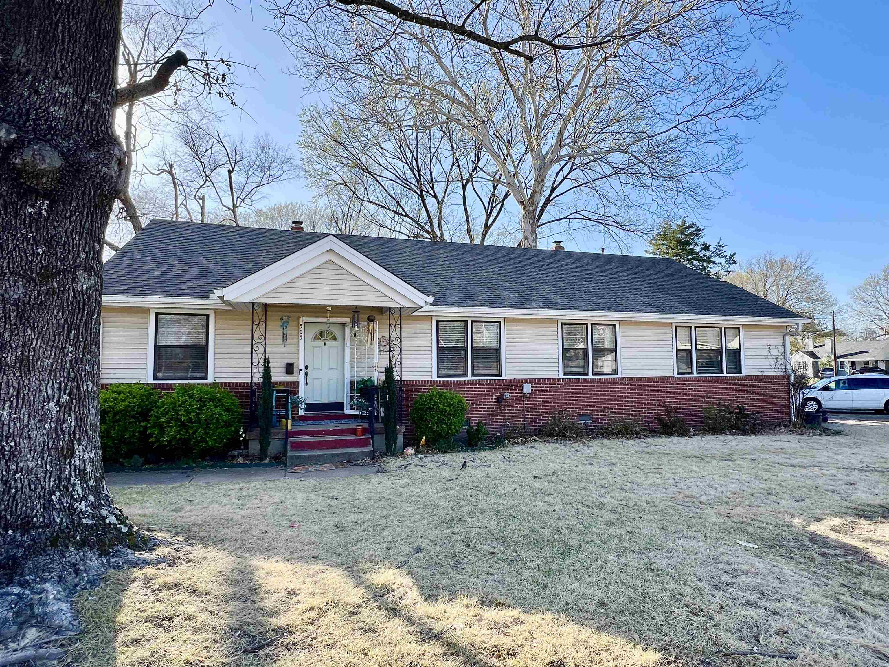 Ranch-style house with brick siding and roof with shingles