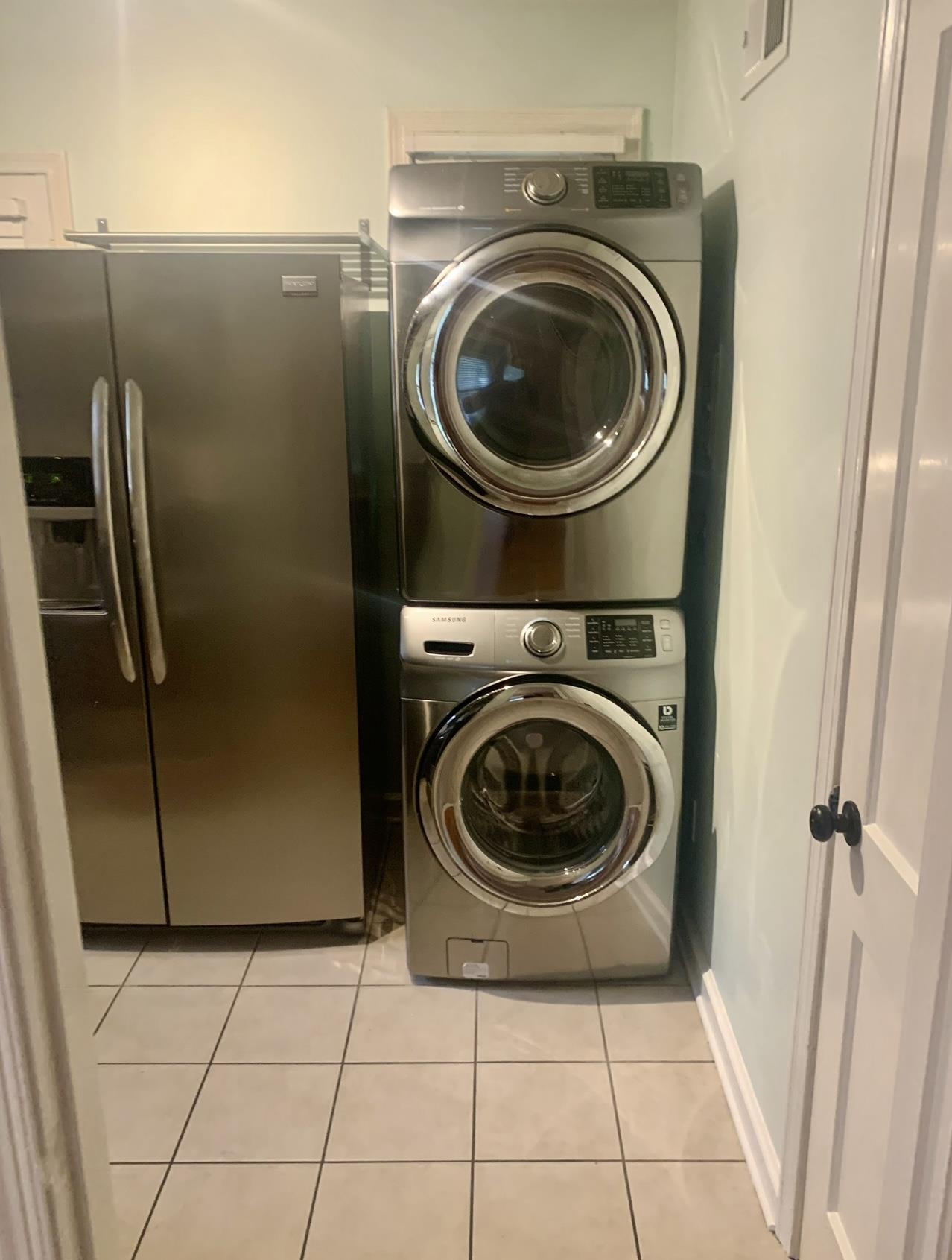 505 High Point Terrace Memphis, TN 38122 - Photo 11 of 29 Clothes washing area featuring stacked washer / dryer, laundry area, and light tile patterned floors