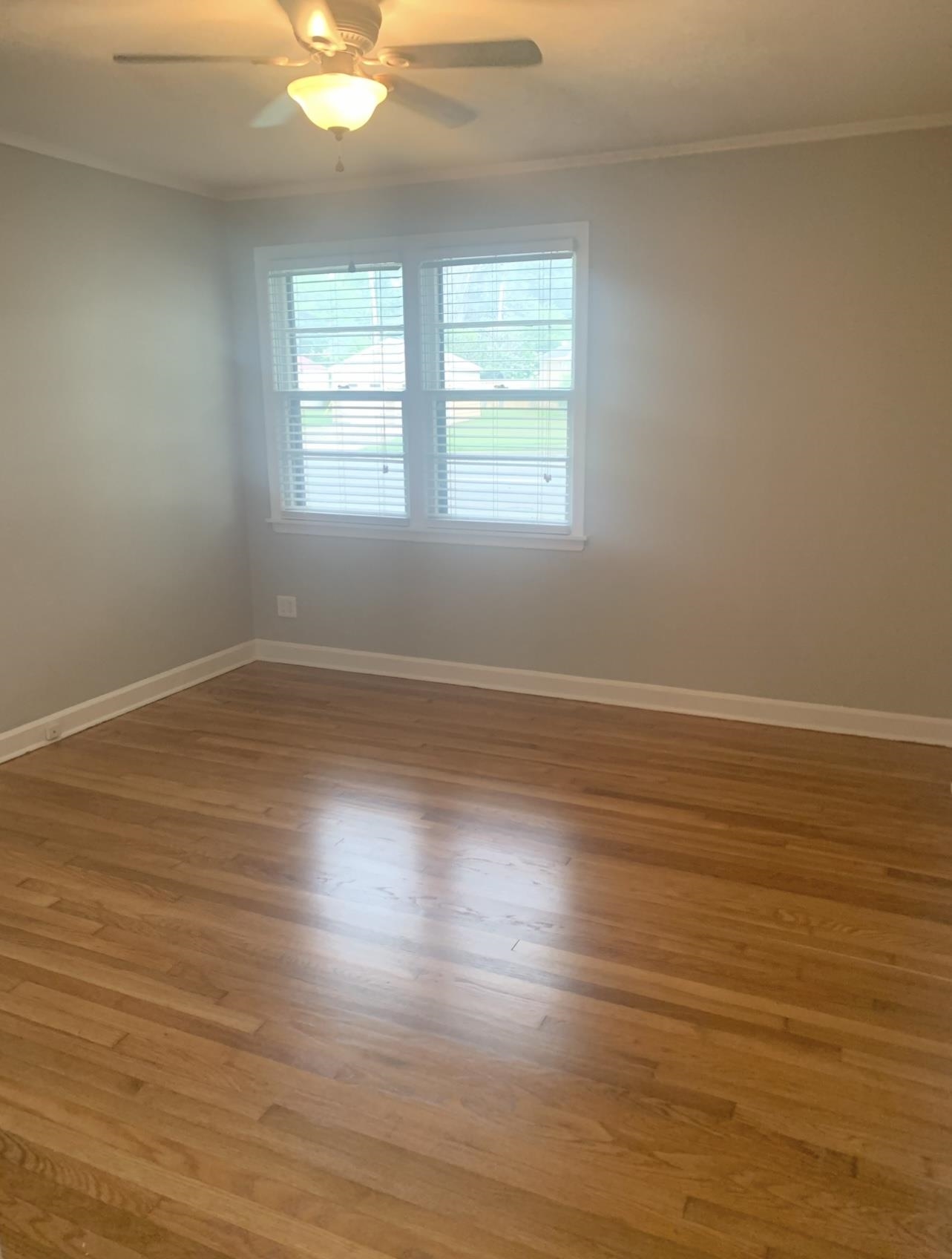 505 High Point Terrace Memphis, TN 38122 - Photo 13 of 29 Empty room featuring baseboards, ornamental molding, ceiling fan, and light wood-type flooring