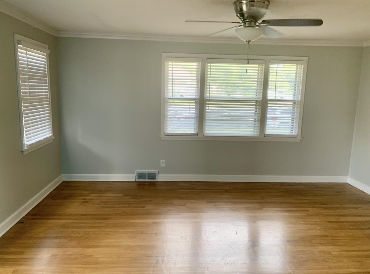 505 High Point Terrace Memphis, TN 38122 - Photo 18 of 29 Empty room featuring visible vents, crown molding, wood finished floors, and ceiling fan
