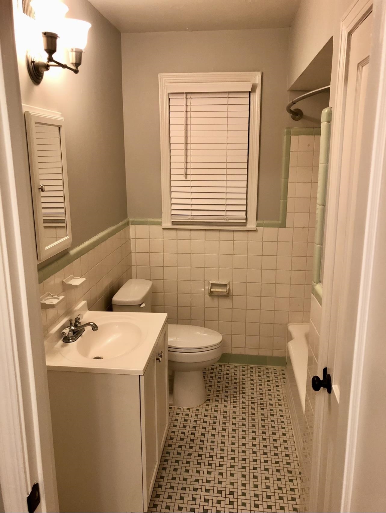 505 High Point Terrace Memphis, TN 38122 - Photo 24 of 29 Bathroom featuring tile walls, toilet, vanity, and wainscoting