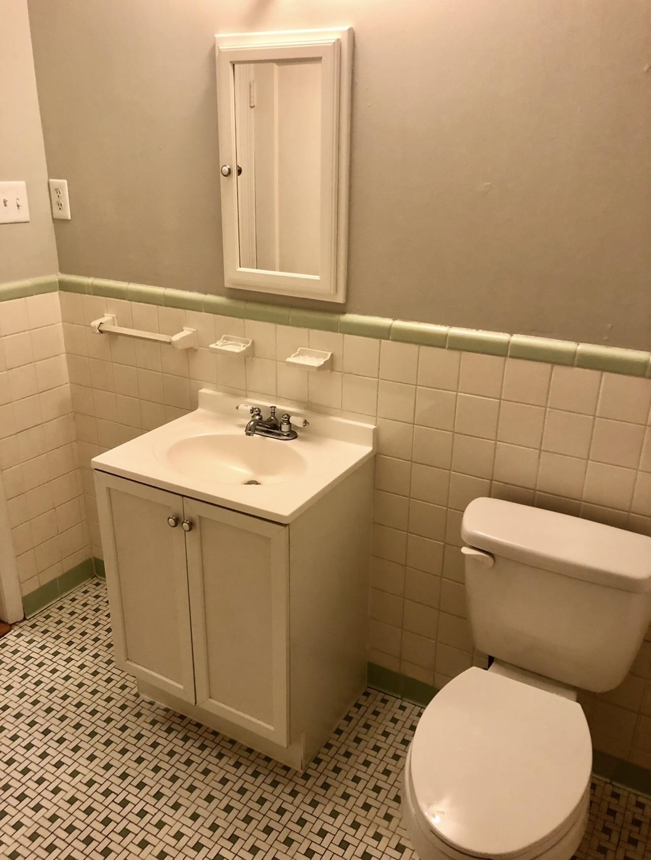 505 High Point Terrace Memphis, TN 38122 - Photo 25 of 29 Half bathroom featuring toilet, vanity, tile patterned flooring, and wainscoting