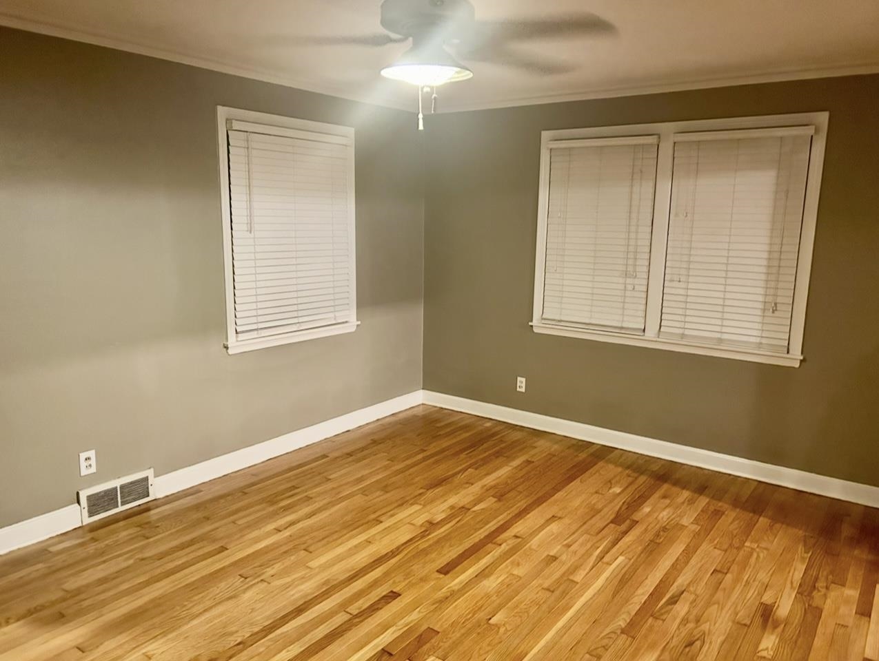 505 High Point Terrace Memphis, TN 38122 - Photo 6 of 29 Empty room with wood finished floors, baseboards, visible vents, ceiling fan, and ornamental molding