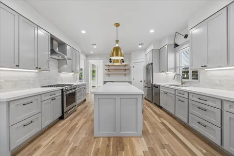 a kitchen with counter top space appliances and cabinets