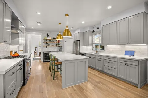 a view of a kitchen with furniture and wooden floor