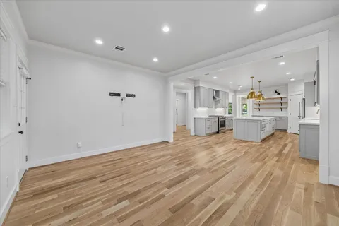 a living room with furniture and kitchen view