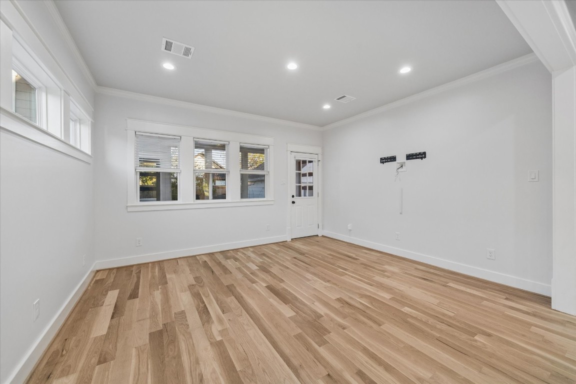 910 Northwood Street Houston, TX 77009 - Photo 17 of 41 a view of empty room with wooden floor and fan