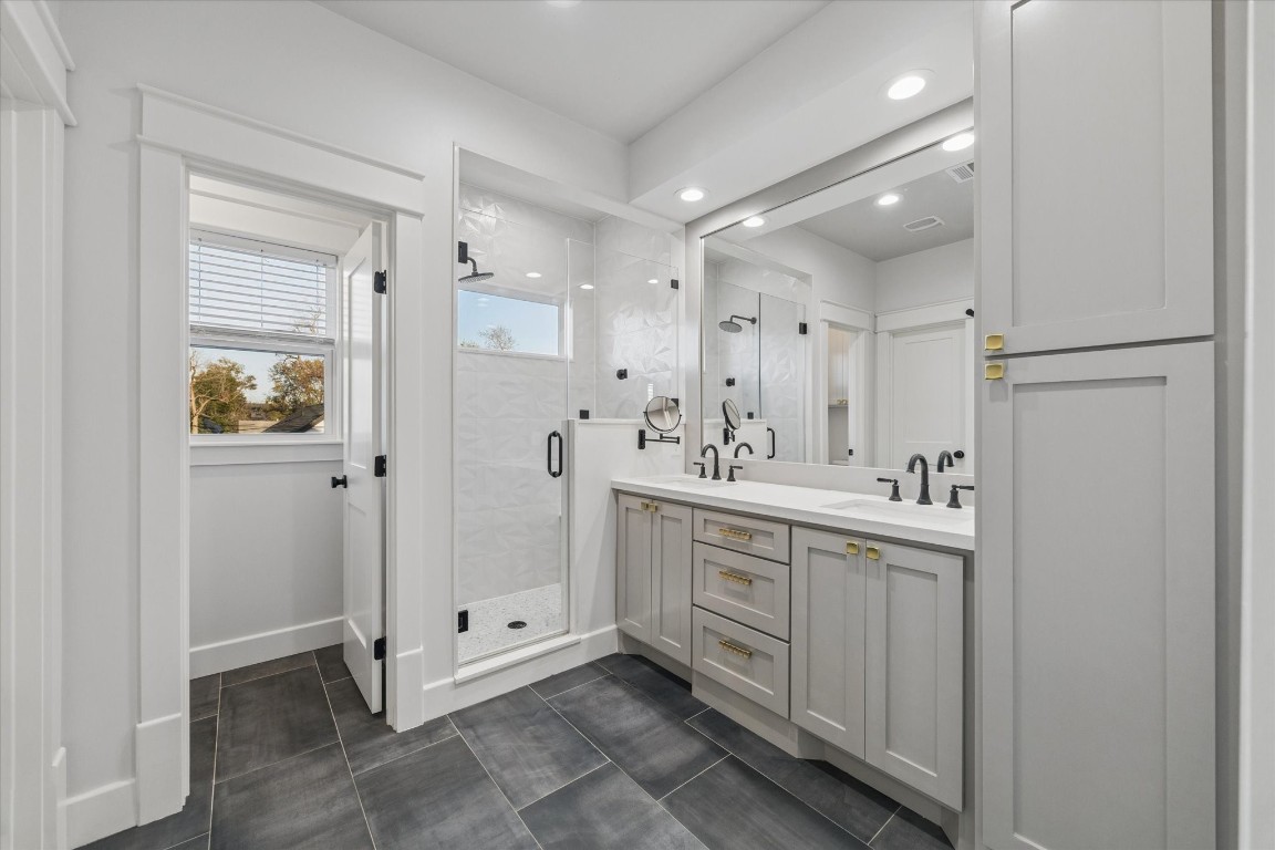 910 Northwood Street Houston, TX 77009 - Photo 25 of 41 a bathroom with a double vanity sink mirror and shower