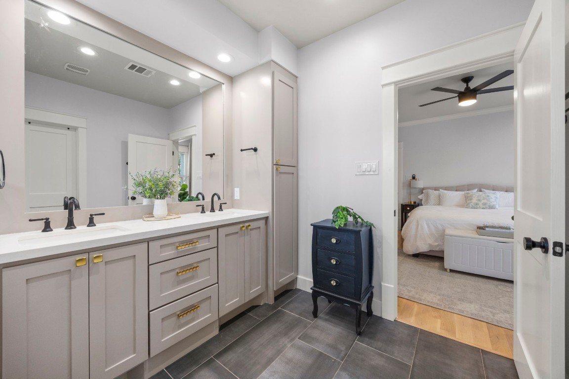 910 Northwood Street Houston, TX 77009 - Photo 26 of 41 a en suite bathroom with a double vanity sink and mirror