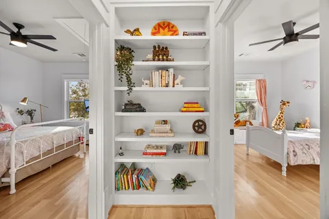 a bathroom with a double vanity sink a toilet and a bathtub