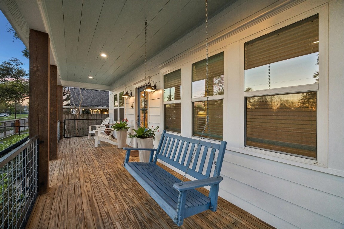 910 Northwood Street Houston, TX 77009 - Photo 3 of 41 a view of a balcony with chairs and wooden floor