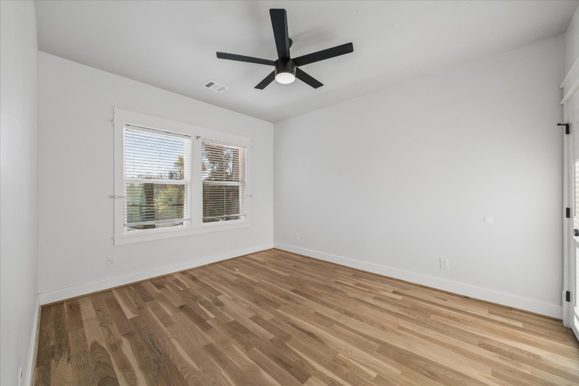 910 Northwood Street Houston, TX 77009 - Photo 31 of 41 a view of empty room with wooden floor and fan
