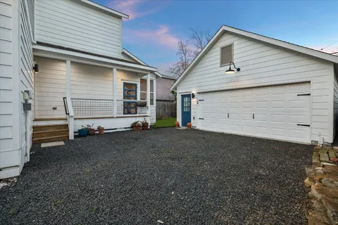 a view of a dining room with furniture a potted plant and wooden floor