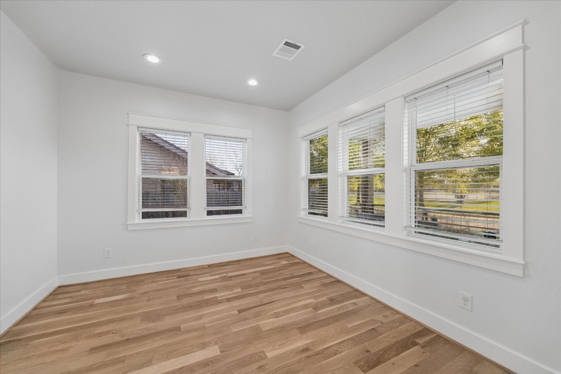 910 Northwood Street Houston, TX 77009 - Photo 8 of 41 a view of an empty room with wooden floor and a window