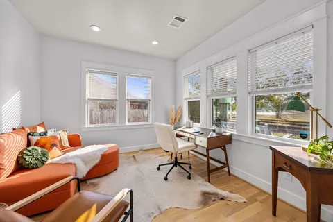 a kitchen with stainless steel appliances granite countertop a refrigerator a stove a sink and a oven