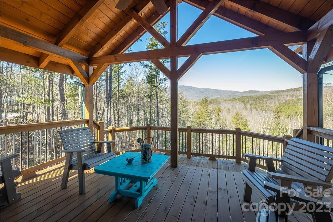 9589 Shortoff View Terrace, Unit 29 Nebo, NC 28761 - Photo 21 of 25 a view of a balcony with furniture and wooden floor