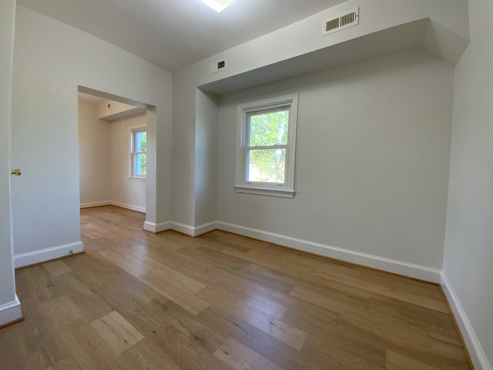 1772 E Street Northeast Washington, DC 20002 - Photo 12 of 23 an empty room with wooden floor and windows