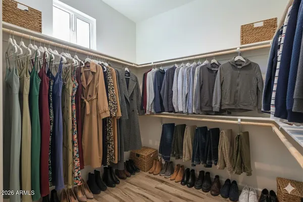 a view of walk in closet with clothes