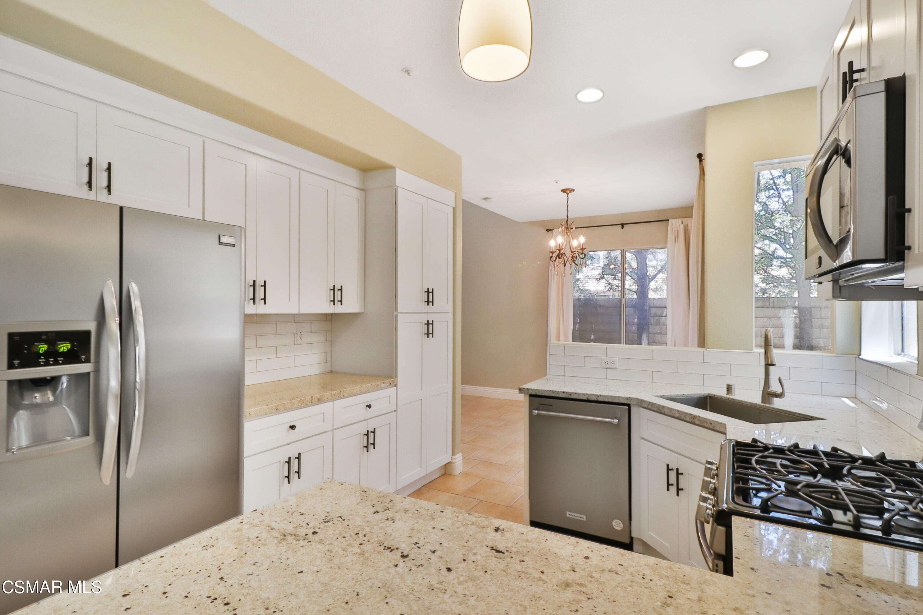 292 Maywind Lane Simi Valley, CA 93065 - Photo 17 of 41 a kitchen with stainless steel appliances granite countertop a sink stove and refrigerator