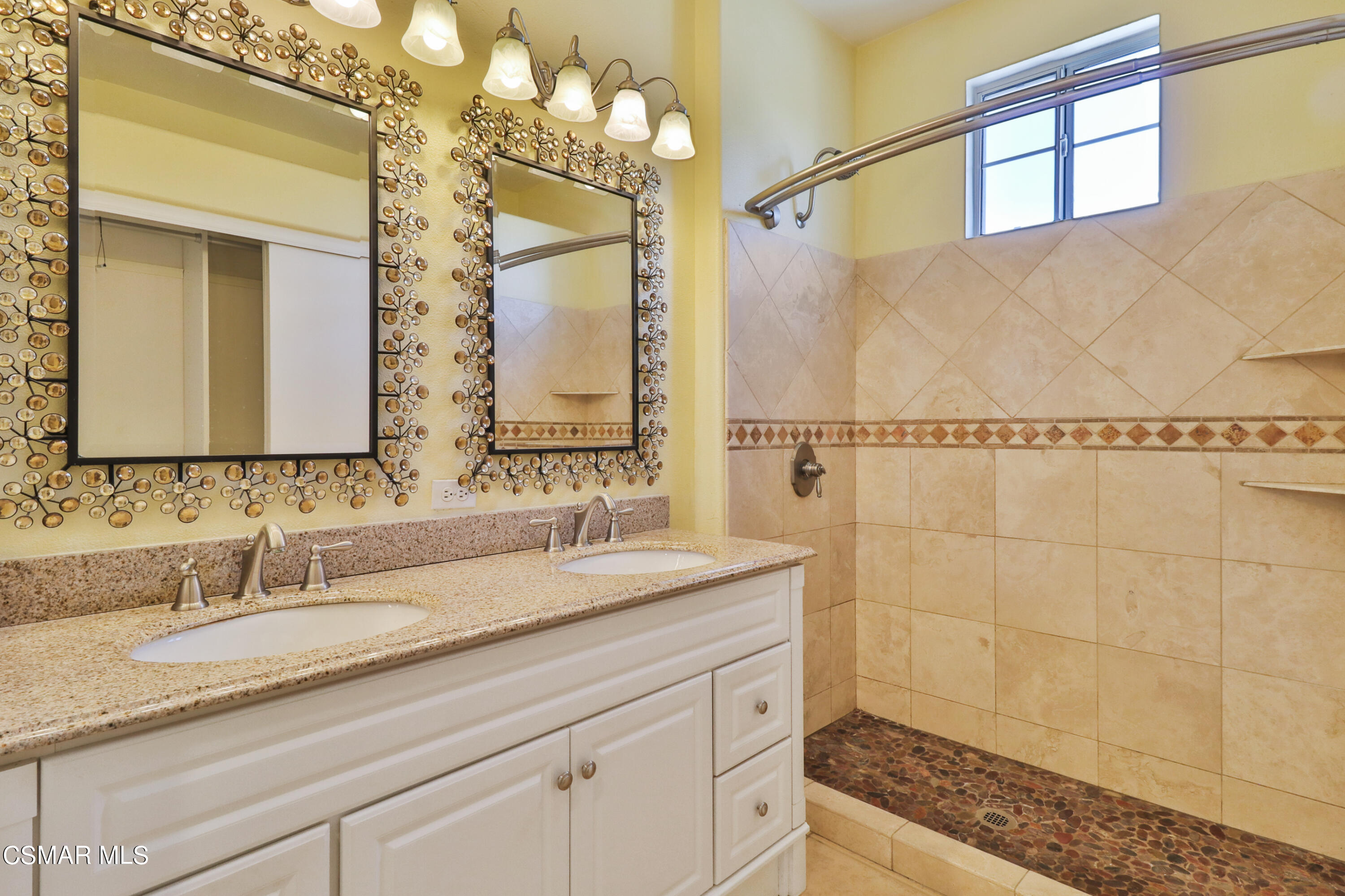 292 Maywind Lane Simi Valley, CA 93065 - Photo 29 of 41 a bathroom with a granite countertop sink a mirror a vanity and shower