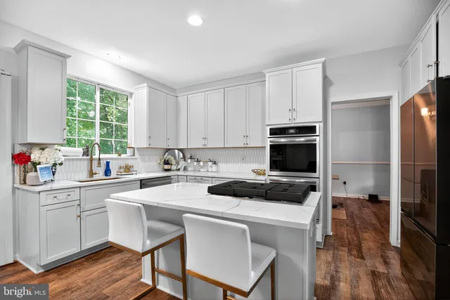 a kitchen with a stove a sink and a refrigerator