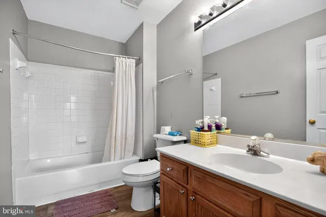 a bathroom with a sink mirror toilet and shower