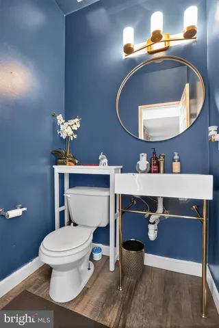 a bathroom with a toilet sink and mirror