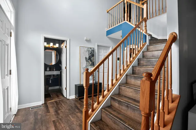 a view of entryway and hall with wooden floor