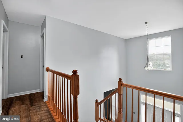 a view of a hallway with a window and stairs