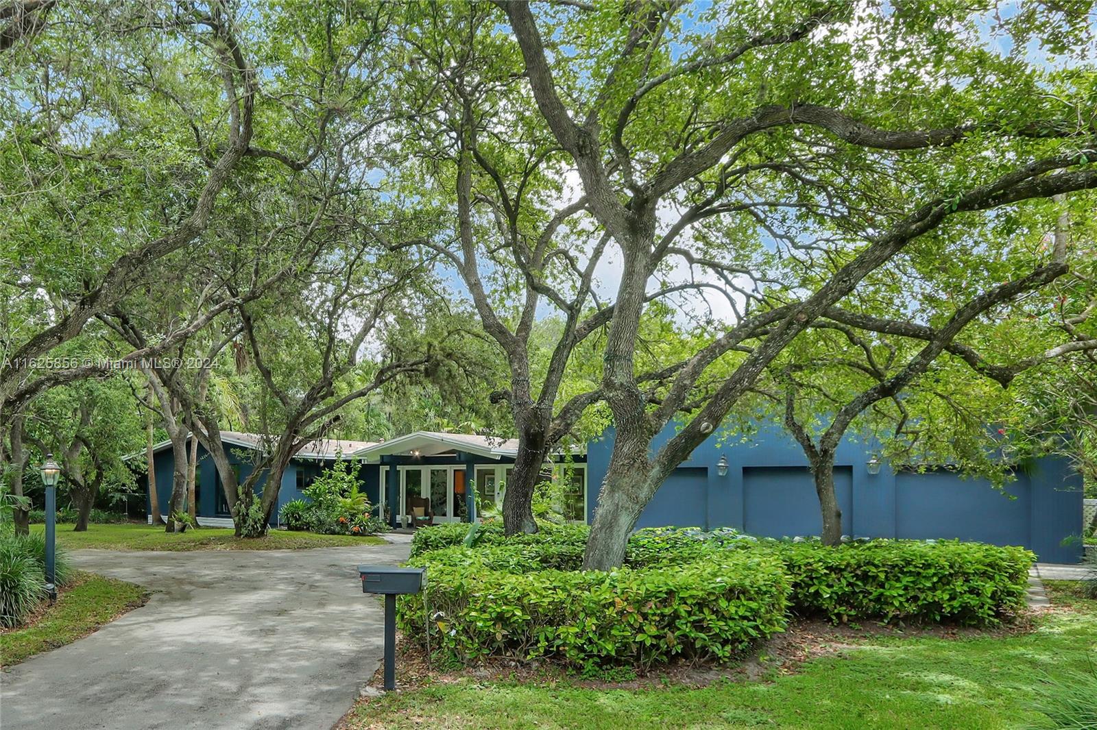 9290 Southwest 117th Terrace Miami, FL 33176 - Photo 1 of 26 a front view of a house with a yard